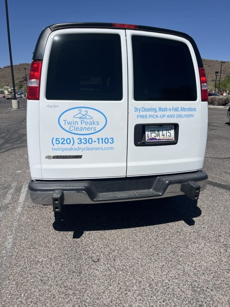 A white van displays "Twin Peaks Cleaners" logo, contact number, website, and details about dry cleaning and free pick-up and delivery services.